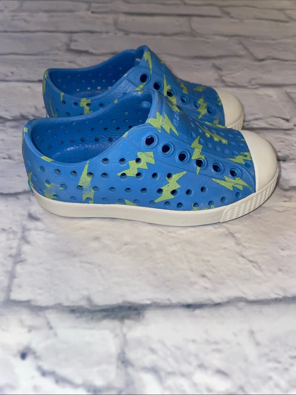 Native Jefferson Blue Slip-On with Neon Lightning Bolts. Size 5